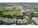 Picturesque aerial view of community with golf course, lush greenery, and beautiful homes at 776 Grasslands Village Cir # 776, Lakeland, FL 33803