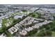 Wide aerial shot showcases a well-planned community with ponds, trees, and residential areas at 776 Grasslands Village Cir # 776, Lakeland, FL 33803
