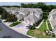 Aerial view of townhomes showcasing well-manicured landscaping and roof design at 776 Grasslands Village Cir # 776, Lakeland, FL 33803