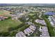 Expansive aerial view of golf course community featuring multiple fairways, ponds, and residences at 776 Grasslands Village Cir # 776, Lakeland, FL 33803