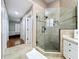 Modern bathroom with glass shower, tiled walls, and a view to the bedroom at 776 Grasslands Village Cir # 776, Lakeland, FL 33803
