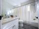 Bathroom with white vanity, toilet, shower with curtain, and tile flooring at 776 Grasslands Village Cir # 776, Lakeland, FL 33803