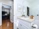 Bathroom with white vanity with view of the bedroom with hardwood floors and a bunk bed at 776 Grasslands Village Cir # 776, Lakeland, FL 33803