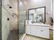 Well-lit bathroom featuring a glass-enclosed shower with tiled walls and modern fixtures at 776 Grasslands Village Cir # 776, Lakeland, FL 33803