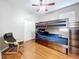 Bedroom with hardwood floors, a bunk bed, a ceiling fan, a closet, and a black chair at 776 Grasslands Village Cir # 776, Lakeland, FL 33803