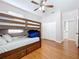 Bedroom featuring hardwood floors, a bunk bed, and a ceiling fan, as well as a closet at 776 Grasslands Village Cir # 776, Lakeland, FL 33803
