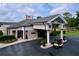 Exterior view of the clubhouse entrance featuring a covered entryway, manicured landscaping, and convenient parking at 776 Grasslands Village Cir # 776, Lakeland, FL 33803