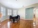 Bright dining room featuring hardwood floors, plantation shutters, and a stylish dining set at 776 Grasslands Village Cir # 776, Lakeland, FL 33803