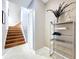 Light-filled entryway featuring a staircase, tiled floor, and shelving unit for storage and decor at 776 Grasslands Village Cir # 776, Lakeland, FL 33803