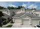 Exterior of town home, featuring a neutral color, a two car garage and a tile roof at 776 Grasslands Village Cir # 776, Lakeland, FL 33803