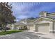 Well-maintained residential townhome displaying lush landscaping, a paved driveway, and an attached garage at 776 Grasslands Village Cir # 776, Lakeland, FL 33803