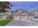 Charming townhomes featuring attached garages and landscaped front yards with beautiful lawn at 776 Grasslands Village Cir # 776, Lakeland, FL 33803