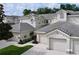 Charming townhouses featuring tile roofs, two-car garages, and well-maintained landscaping at 776 Grasslands Village Cir # 776, Lakeland, FL 33803