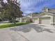 Attractive townhome exterior with manicured lawn and large driveway at 776 Grasslands Village Cir # 776, Lakeland, FL 33803