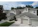 Exterior of town home, featuring a neutral color, a two car garage and a tile roof at 776 Grasslands Village Cir # 776, Lakeland, FL 33803