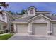 Beautiful townhome showcasing lush landscaping and an attached two car garage at 776 Grasslands Village Cir # 776, Lakeland, FL 33803