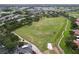 Scenic aerial view of golf course fairways, sand traps, and lush green landscape at 776 Grasslands Village Cir # 776, Lakeland, FL 33803