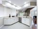 Spacious kitchen featuring white cabinetry, stainless steel appliances, and a tile floor at 776 Grasslands Village Cir # 776, Lakeland, FL 33803