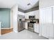 Well-equipped kitchen with stainless steel appliances, white cabinets, and access to the living area at 776 Grasslands Village Cir # 776, Lakeland, FL 33803