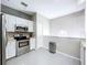 Bright kitchen with stainless steel appliances, tile backsplash, and white cabinets at 776 Grasslands Village Cir # 776, Lakeland, FL 33803