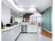 Bright kitchen with stainless steel appliances, white cabinetry, and a view of the living area at 776 Grasslands Village Cir # 776, Lakeland, FL 33803