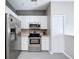 Modern kitchen featuring stainless steel appliances, including refrigerator, oven and microwave at 776 Grasslands Village Cir # 776, Lakeland, FL 33803