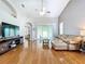 Spacious living room featuring hardwood floors, high ceilings, and a sliding glass door to the outside at 776 Grasslands Village Cir # 776, Lakeland, FL 33803