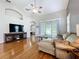 Cozy living room with hardwood floors, vaulted ceiling, and access to the outdoor patio at 776 Grasslands Village Cir # 776, Lakeland, FL 33803