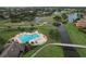 Aerial view shows a unique heart shaped pool surrounded by tropical landscaping at 776 Grasslands Village Cir # 776, Lakeland, FL 33803