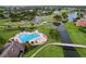 Beautiful heart-shaped pool area surrounded by manicured landscaping, palm trees, and walkways at 776 Grasslands Village Cir # 776, Lakeland, FL 33803