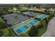 A high angle shows multiple, well maintained tennis and pickle ball courts at 776 Grasslands Village Cir # 776, Lakeland, FL 33803