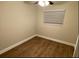 Neutral bedroom with wood-look flooring, ceiling fan, and a window with blinds at 1864 Williams Manor Ave, Orlando, FL 32811