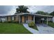 Modest single-story home featuring a covered carport and a well-maintained lawn at 1864 Williams Manor Ave, Orlando, FL 32811
