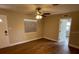 Bright living room with wood-look floors, ceiling fan, and natural light from a window at 1864 Williams Manor Ave, Orlando, FL 32811