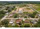 A community aerial view showcasing the neighborhood's layout, with houses, streets, and proximity to lakes and open land at 3983 Shay Dr, Bartow, FL 33830