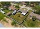A fenced backyard view with a well maintained lawn and a RV, plus the house's layout and surrounding landscape at 3983 Shay Dr, Bartow, FL 33830