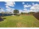Expansive backyard featuring a large lawn area, wooden fence, and a well-maintained garden at 3983 Shay Dr, Bartow, FL 33830