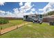 Manicured backyard featuring a RV, gravel path, and ample space for recreation and relaxation at 3983 Shay Dr, Bartow, FL 33830