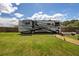 Backyard featuring a parked RV and gravel pathway. Plenty of room for recreation at 3983 Shay Dr, Bartow, FL 33830