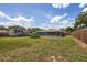 Spacious backyard with lush green lawn, screened in porch, and plenty of space for outdoor activities at 3983 Shay Dr, Bartow, FL 33830
