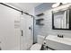 Modern bathroom features a sleek glass shower, stylish shiplap wall, and floating shelves for a spa-like feel at 3983 Shay Dr, Bartow, FL 33830