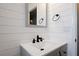 Close-up on bathroom vanity with modern faucet, gray cabinet and a decorative framed mirror at 3983 Shay Dr, Bartow, FL 33830