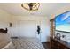 Bedroom with modern ceiling fan, spacious closets and dresser beneath a large screen TV at 3983 Shay Dr, Bartow, FL 33830