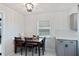 Cozy dining area with modern lighting, a window, and an adjacent kitchen area with sleek finishes at 3983 Shay Dr, Bartow, FL 33830