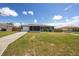 Single-Gathering home with manicured lawn, covered porch, and attached garage on a sunny day at 3983 Shay Dr, Bartow, FL 33830