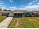 Aerial shot of home showing covered porch, attached garage, nice lawn, and wooden perimeter fence at 3983 Shay Dr, Bartow, FL 33830
