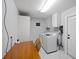 Well-organized laundry room featuring modern washer and dryer, storage cabinets, and functional workspace at 3983 Shay Dr, Bartow, FL 33830