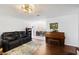 Open-concept living room featuring hardwood floors, a stylish rug, and an adjacent dining area at 3983 Shay Dr, Bartow, FL 33830