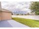 Private back yard featuring a well-maintained lawn and white vinyl privacy fence at 547 Sardinia Cir, Davenport, FL 33837