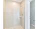 A bathroom features a glass-enclosed shower with tiled walls at 547 Sardinia Cir, Davenport, FL 33837